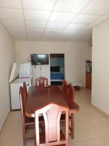 a dining room with a wooden table and chairs at Coastal Apartment in Monte Caseros
