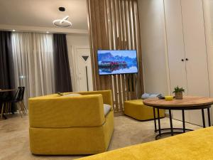 a living room with two yellow chairs and a table at Ancient Philippi Luxury Apt MKP in Krinídhes