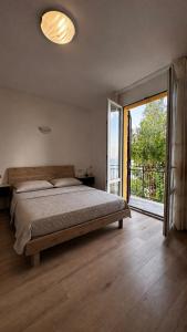 a bedroom with a large bed and a large window at Villa sul mare di Cupra in Cupra Marittima