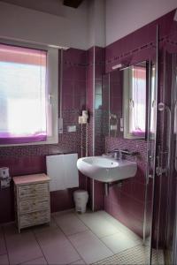 a bathroom with a sink and a toilet at Alloggio Le Macine in Ferrara +31 photos