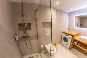 a bathroom with a shower and a washing machine at Kantouni Corfu in Potamós +44 photos