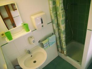 a small bathroom with a sink and a shower at Zelená chalúpka in Spišská Nová Ves +4 photos