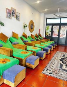 a room with green and blue couches at lotusan in Phú Quốc