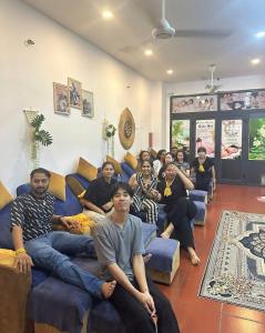 a group of people sitting on couches in a living room at lotusan in Phú Quốc