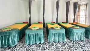 a group of four beds in a room at lotusan in Phú Quốc