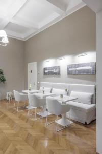 a dining room with white tables and white chairs at Rooms Buonanotte Barbarossa in Prato +18 photos