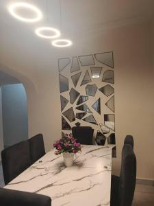 a dining room with a marble table with flowers on it at Hayorttas Apartment in Cardoso