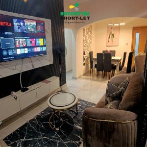 a living room with a tv and a couch and a table at Hayorttas Apartment in Cardoso