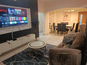 a living room with a tv and a couch and a table at Hayorttas Apartment in Cardoso