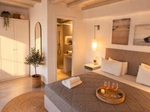 a bedroom with a large bed with a bowl on it at ELEVEN KEYS APARTMENTS in Vrisi/ Mykonos