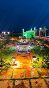 a park lit up at night with lights at Snehdeep Villa, Konkan Trail in Dapoli
