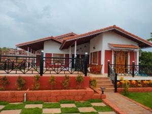 a house with a red and white at Snehdeep Villa, Konkan Trail in Dapoli