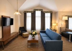 a living room with a blue couch and a tv at Holiday Inn Express Durham-UNH by IHG in Durham