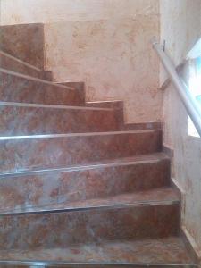a set of stairs with a metal hand rail at 4 Beridze Holiday Home in Batumi