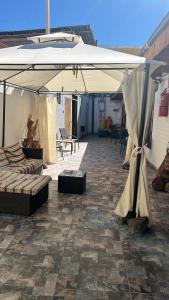 a large white umbrella sitting on a patio at Hostal Malú in San Pedro de Atacama