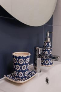 a bathroom counter with a coffee cup and a sink at Corte EDN7 in Sannicandro di Bari +36 photos