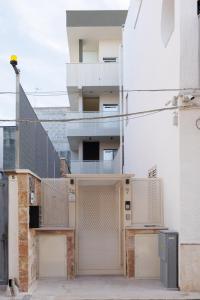 an external view of a building with boarded up windows at Corte EDN7 in Sannicandro di Bari