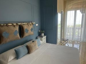 a bedroom with a large bed with blue walls at Villa Antonietta Ischia in Forio d'Ischia