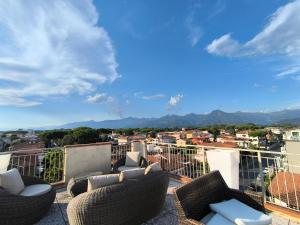 a balcony with chairs and a view of a city at Hotel Verbena in Lido di Camaiore