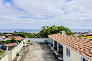 a view of the ocean from the balcony of a house at The Frenchie's House in Rabo de Peixe