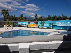 a swimming pool with a mural of the ocean at Apartamento Finca Verde in Las Carreras
