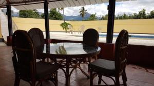 a table and chairs on a patio with a pool at Apartamento Finca Verde in Las Carreras +16 photos