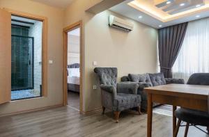 a living room with a couch and chairs and a table at Saltanat Apartment in Istanbul