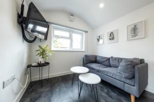 a living room with a couch and a tv at The Snug - Cosy Annexe Hideaway in Portishead