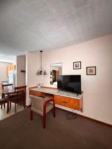 a living room with a desk with a television at Seven Seas in Kure Beach