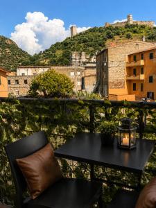 a table and chairs on a balcony with a view at LoFT in Bosa