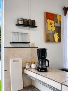 a kitchen with a coffee maker on a counter at Arenal Rental CASA PALMERA UNO in Arenal