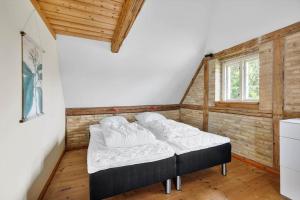 a bedroom with a bed in the corner of a room at SB137-Grasten-Dalsgardvej-12 in Gråsten
