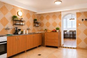 a kitchen with wooden cabinets and a dining room at Rooms Gdynia Orłowo in Gdynia