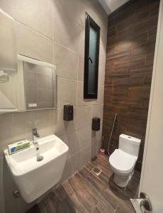 a bathroom with a white sink and a toilet at دره العروس الشاطي in Jeddah +2 photos