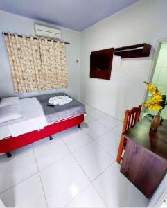 a bedroom with a bed and a desk in it at Hotel Mirage in Alta Floresta