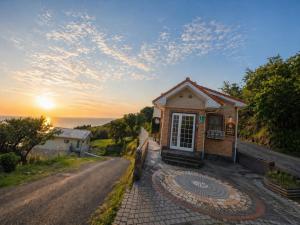a small house on the side of a road at Villa Amoria Ocean View in Miyazaki