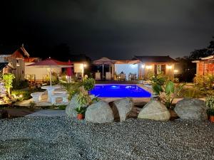 a swimming pool in a yard at night at Kokoro Garden in Fortuna