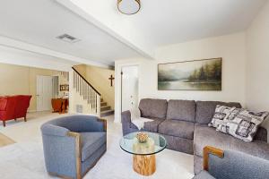 a living room with a couch and a table at The Fairway Chalet in Lake Arrowhead