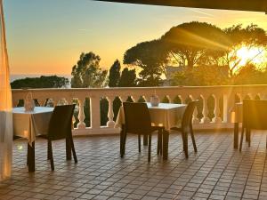 a restaurant with tables and chairs on a balcony at Villa Antonietta Ischia in Forio d'Ischia +74 photos