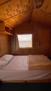 a large bed in a room with a window at Genena Eco-lodge in Nuweiba