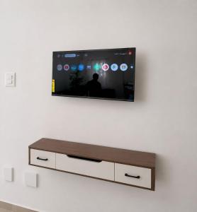 a flat screen tv hanging on a white wall at Alojamiento en Miches in Miches
