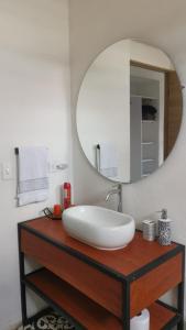 a bathroom with a sink and a mirror at Home Glamping Deluxe in Sáchica