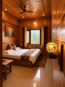 a bedroom with a bed and a window in a room at The Yak House in Chakrāta