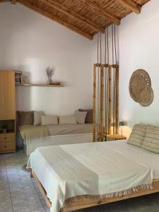 a bedroom with two beds and a couch at The Beach House in Vasilika