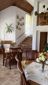 a dining room with a table and chairs and a staircase at Tranzit in Mihai Viteazu +5 photos