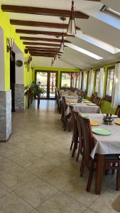 a row of tables and chairs in a restaurant at Tranzit in Mihai Viteazu