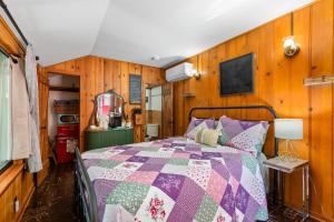 a bedroom with a bed with a quilt on it at Peaceful Cabin in Idyllwild