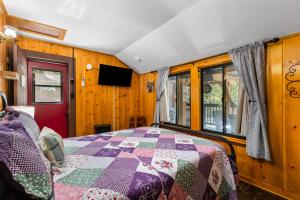 a bedroom with a bed with a quilt on it at Peaceful Cabin in Idyllwild