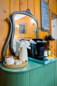 a counter with a mirror and a table with dishes at Peaceful Cabin in Idyllwild