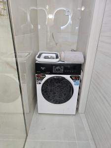 a washing machine sitting in a bathroom next to a toilet at Ktima Voulme in Kavála +13 photos